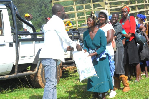 Busha handing mealie-meal to cyclone victims in Chimanimani recently