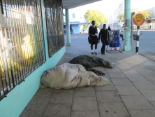 homeless children sleeping in the streets while others go to school