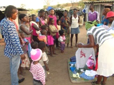 Musician Vekann far right standing with Ngozi children while women fits children. Pic By chrispen Tabvura