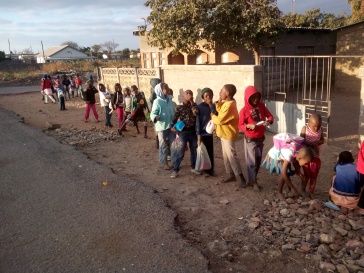 Vulnerable children queuing for food from open hearts soup kitchen
